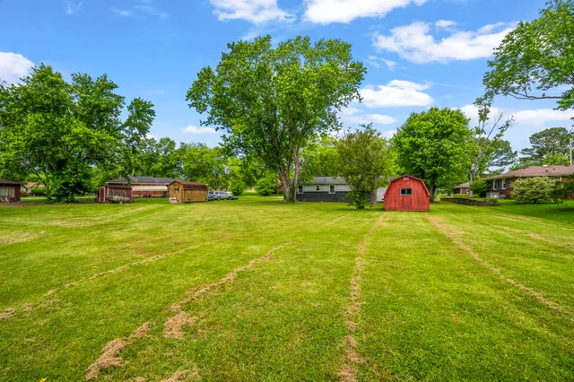a view of house with backyard and garden