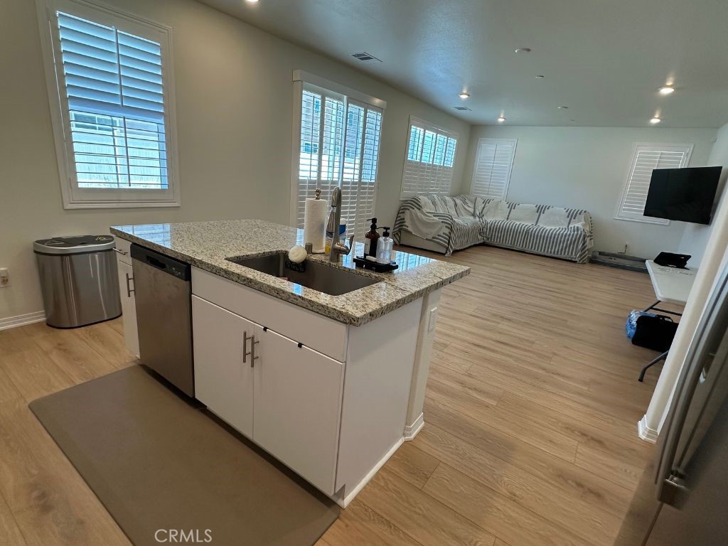 2511 Gunner Ridge Way Rialto, CA 92377 - Photo 12 of 37 a kitchen with a sink and a stove top oven