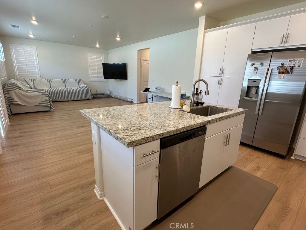 2511 Gunner Ridge Way Rialto, CA 92377 - Photo 13 of 37 a kitchen with stainless steel appliances granite countertop a sink stove and refrigerator