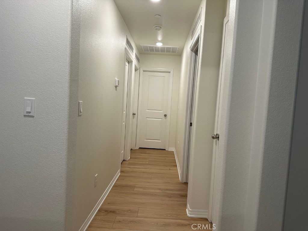 2511 Gunner Ridge Way Rialto, CA 92377 - Photo 16 of 37 a view of a hallway with wooden floor