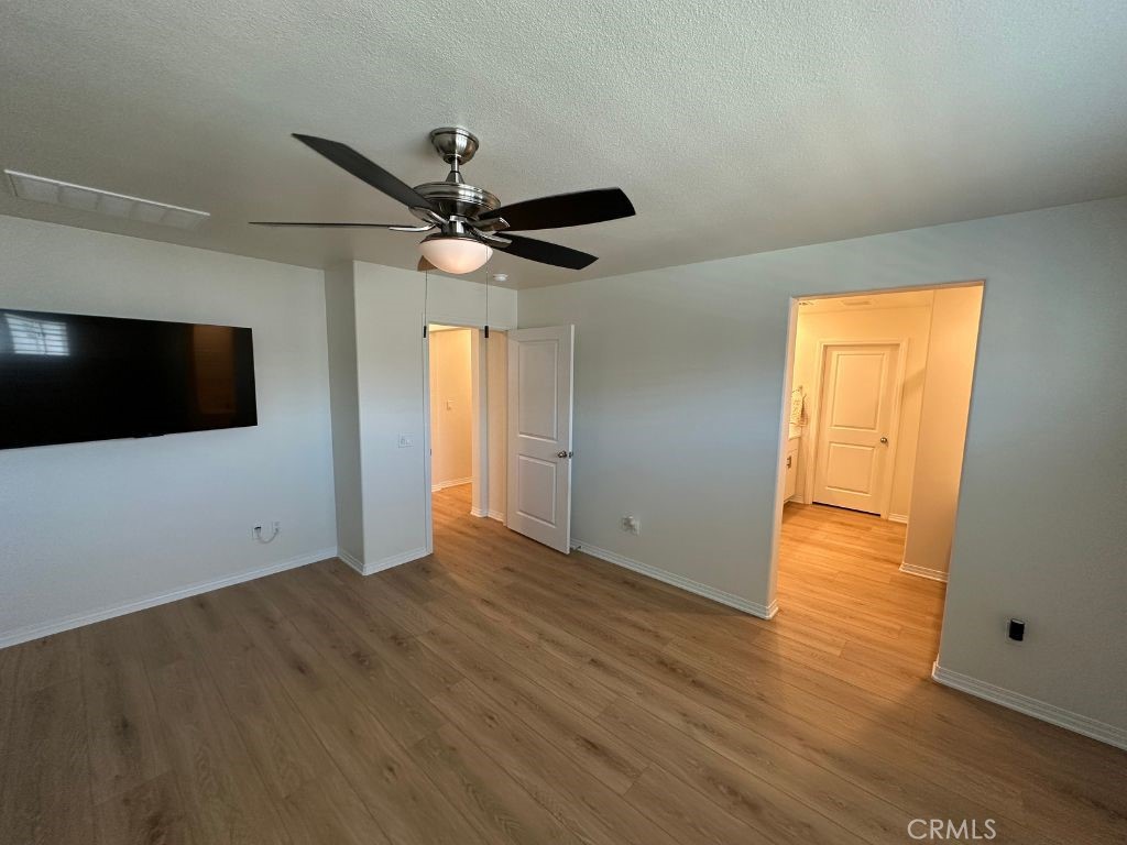 2511 Gunner Ridge Way Rialto, CA 92377 - Photo 19 of 37 a view of an empty room with wooden floor and a window