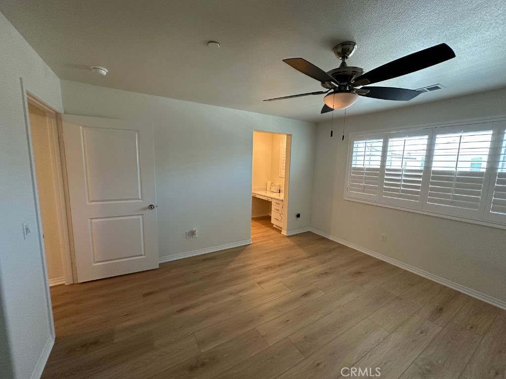 2511 Gunner Ridge Way Rialto, CA 92377 - Photo 20 of 37 a view of an empty room with a window and wooden floor