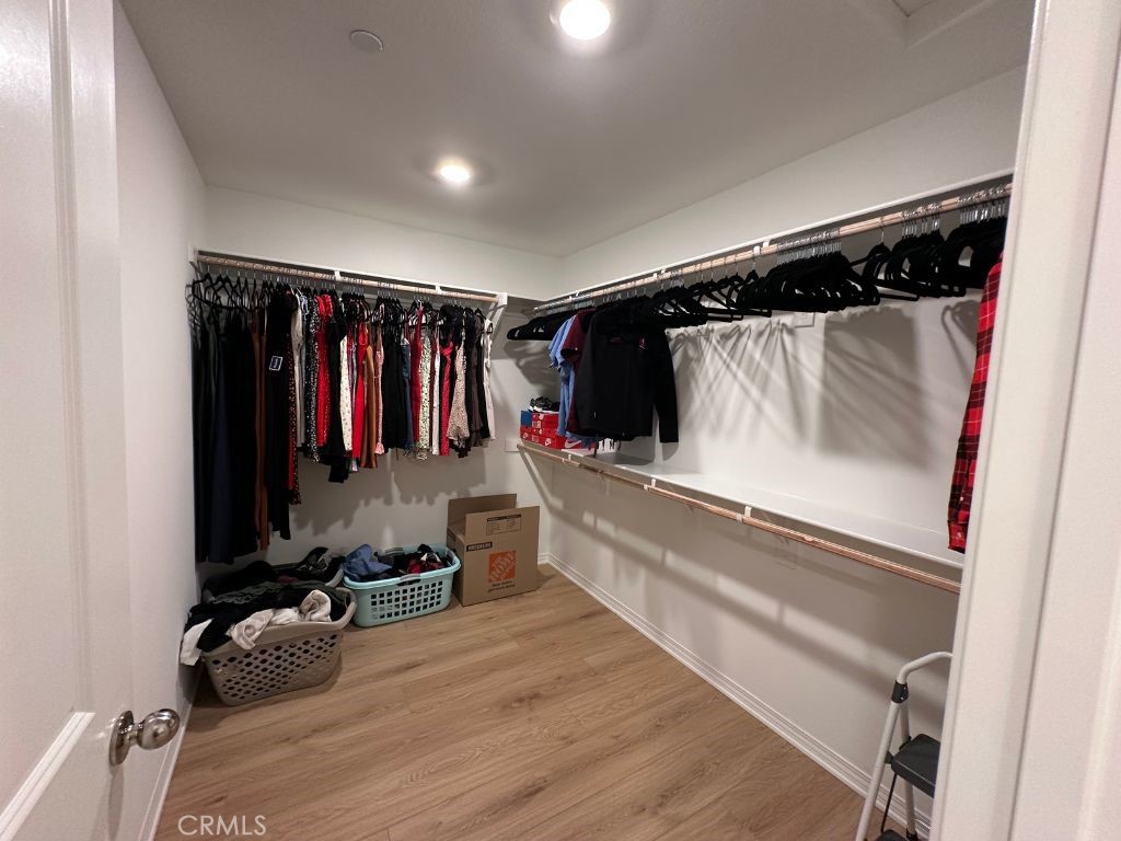 2511 Gunner Ridge Way Rialto, CA 92377 - Photo 23 of 37 a walk in closet with clothes and shoes