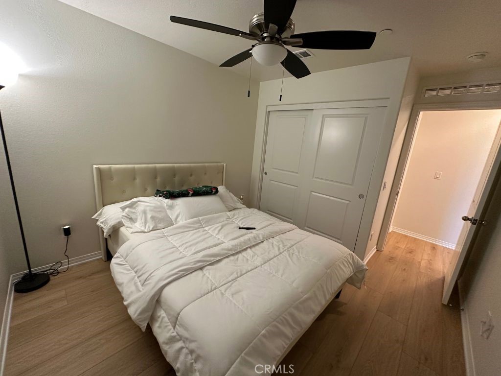 2511 Gunner Ridge Way Rialto, CA 92377 - Photo 25 of 37 a bedroom with a bed and a mirror