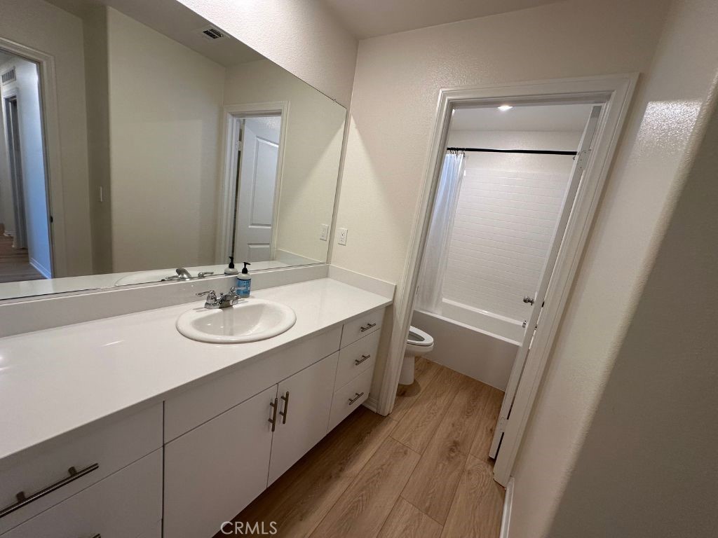 2511 Gunner Ridge Way Rialto, CA 92377 - Photo 28 of 37 a bathroom with a sink and mirror