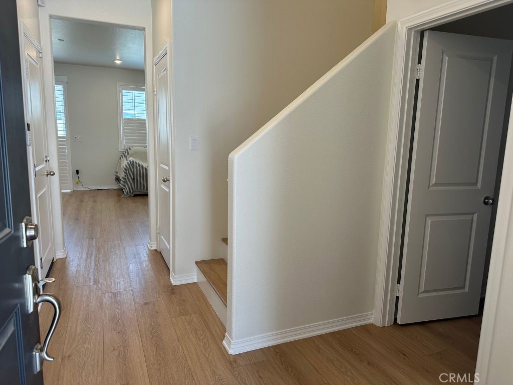 2511 Gunner Ridge Way Rialto, CA 92377 - Photo 8 of 37 a view of a hallway with wooden floor and closet