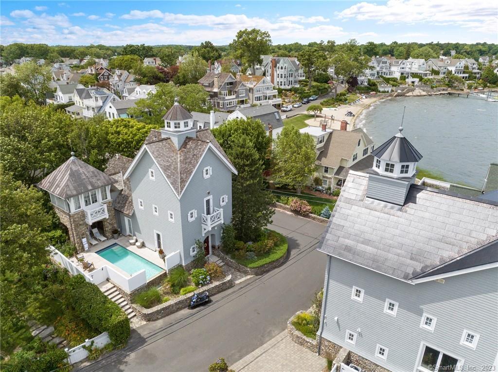 an aerial view of a house with a garden and lake view