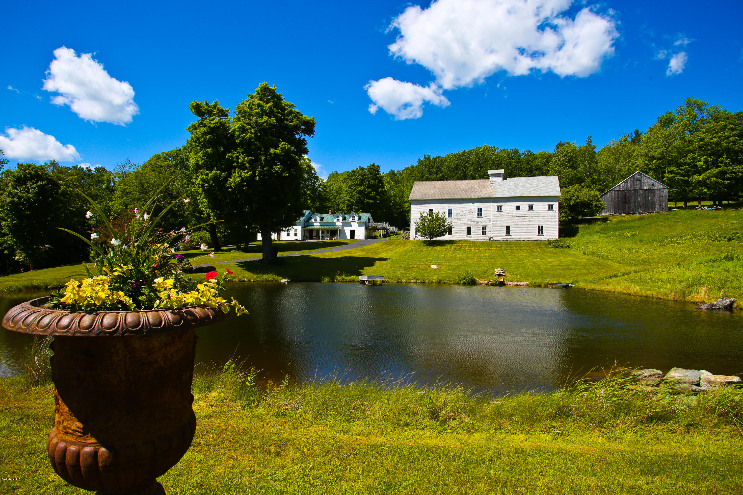 137 Leshure Road Rowe, MA 01367 - Photo 8 of 56 a view of a lake with a house in the background