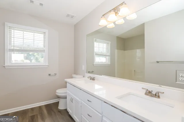 a bathroom with a sink vanity and a mirror