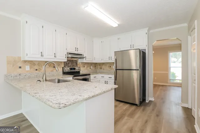 a kitchen with a refrigerator a stove a sink and a refrigerator