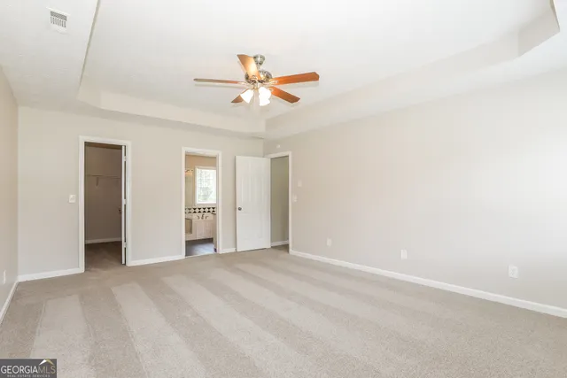 a view of a livingroom with a ceiling fan and window