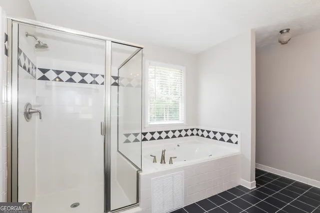 a bathroom with a bathtub and a shower