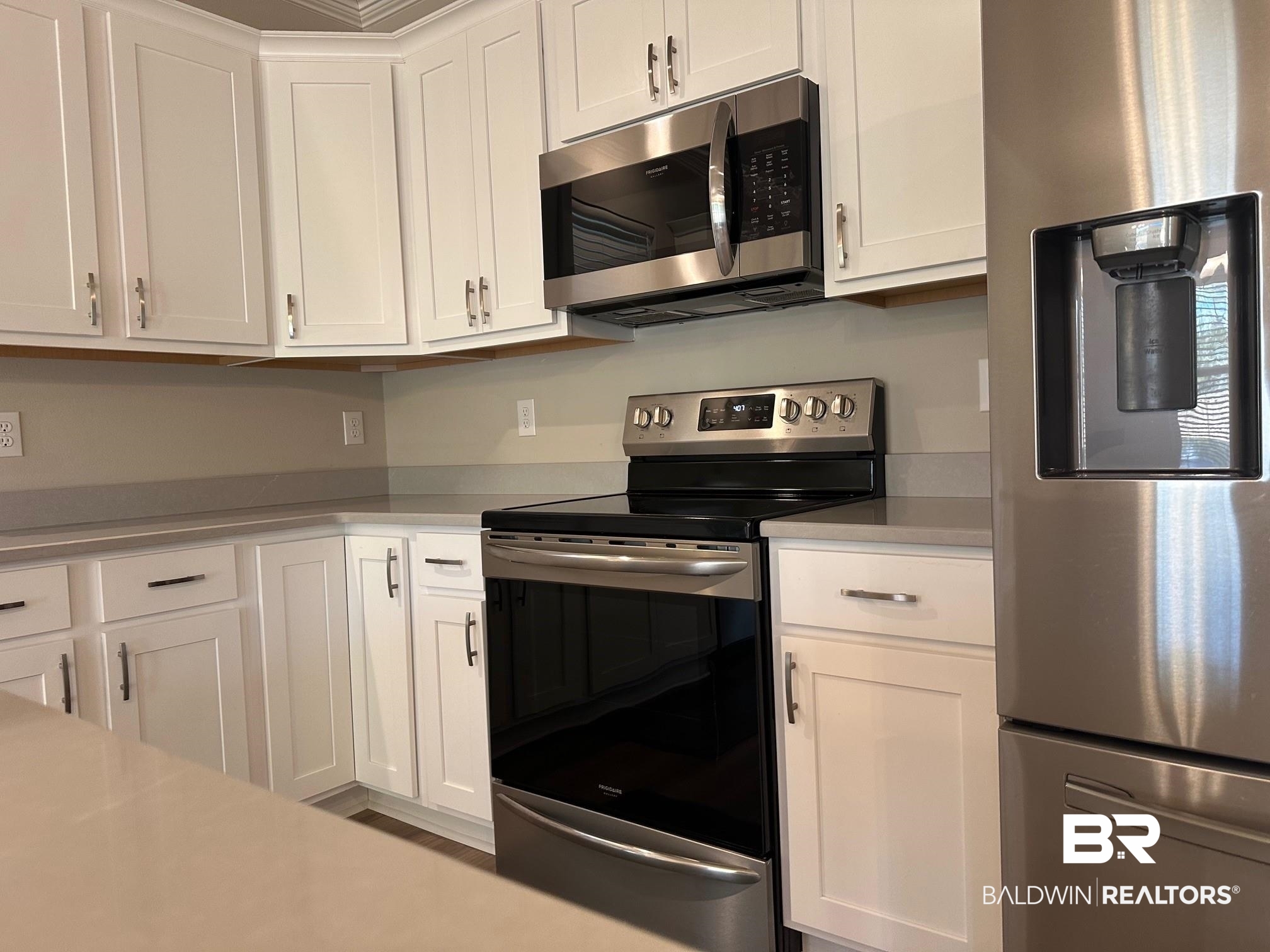 1009 Ruisseau Drive Foley, AL 36535 - Photo 27 of 55 Kitchen featuring appliances with stainless steel finishes and white cabinets