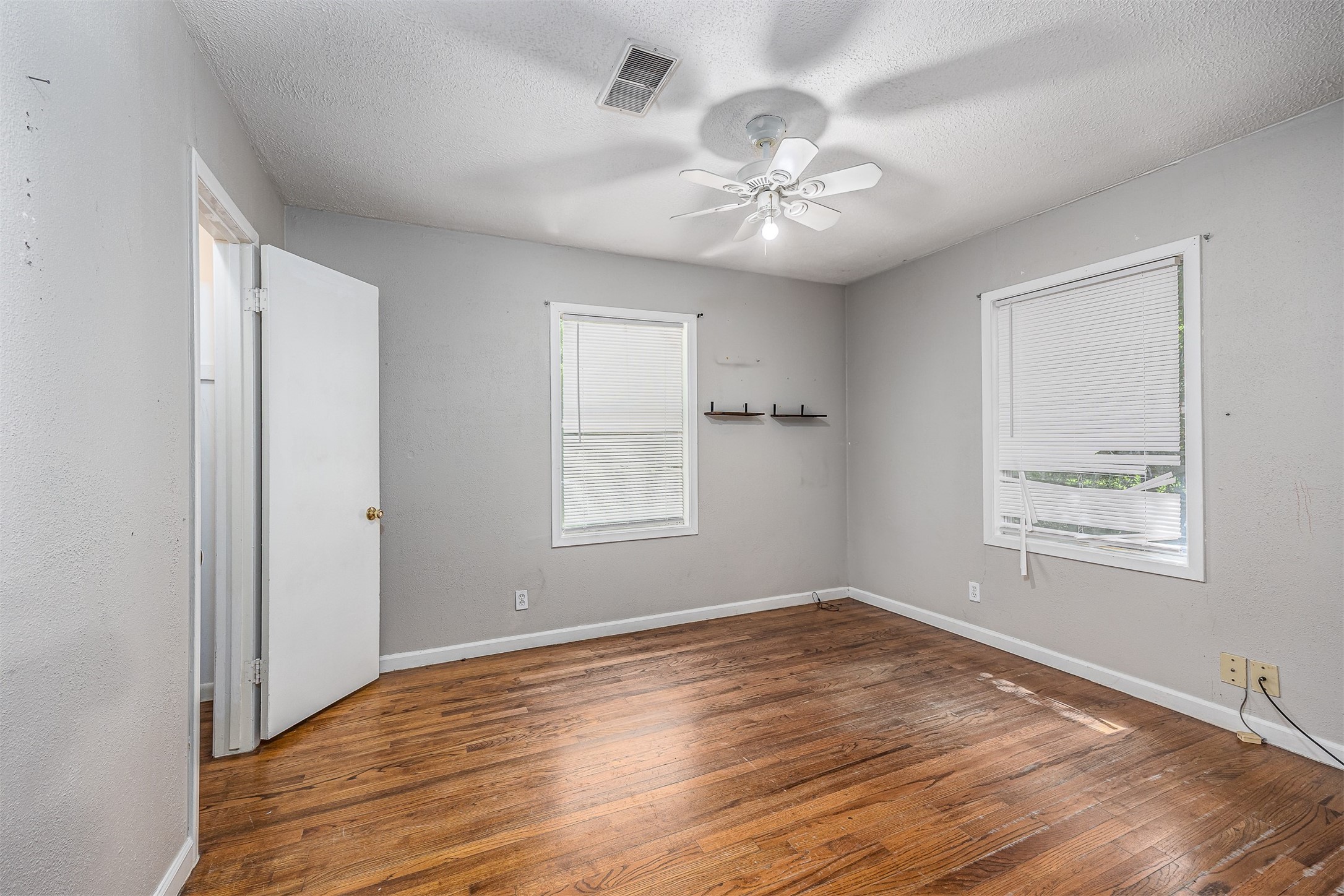 502 Massey Tompkins Road Baytown, TX 77521 - Photo 17 of 32 a view of an empty room with wooden floor and a window