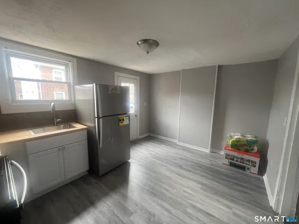 a kitchen with a refrigerator and a sink