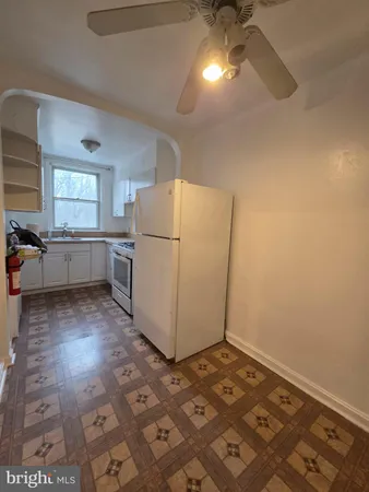 a kitchen with a refrigerator and a stove top oven