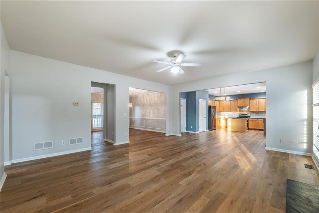1280 Hidden Creek Point Cumming, GA 30040 - Photo 11 of 62 a view of an empty room with window and wooden floor