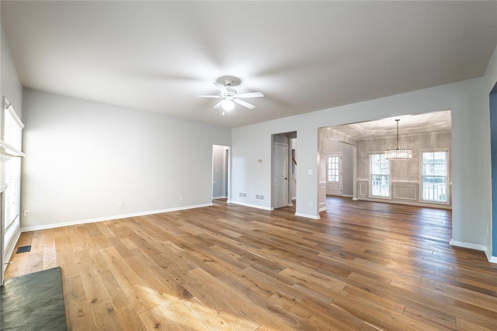 1280 Hidden Creek Point Cumming, GA 30040 - Photo 12 of 62 a view of an empty room with window and wooden floor