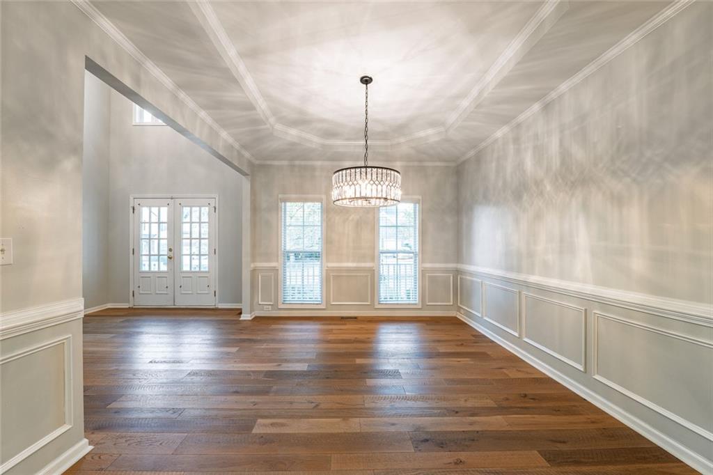 1280 Hidden Creek Point Cumming, GA 30040 - Photo 14 of 62 a view of an empty room with wooden floor and a window