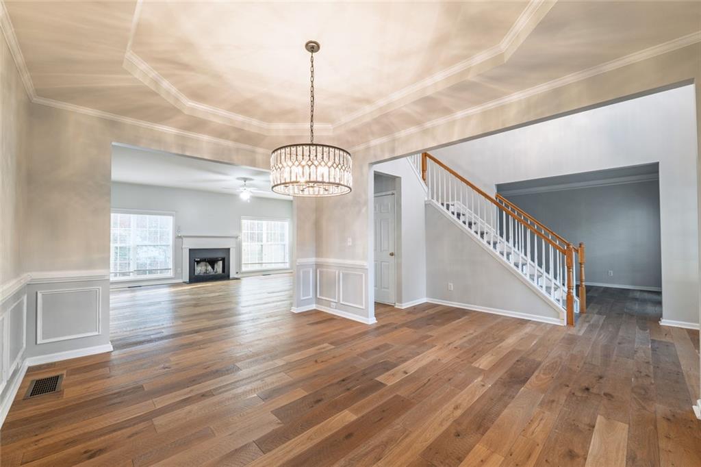 1280 Hidden Creek Point Cumming, GA 30040 - Photo 15 of 62 a view of a room with wooden floor chandelier and entryway