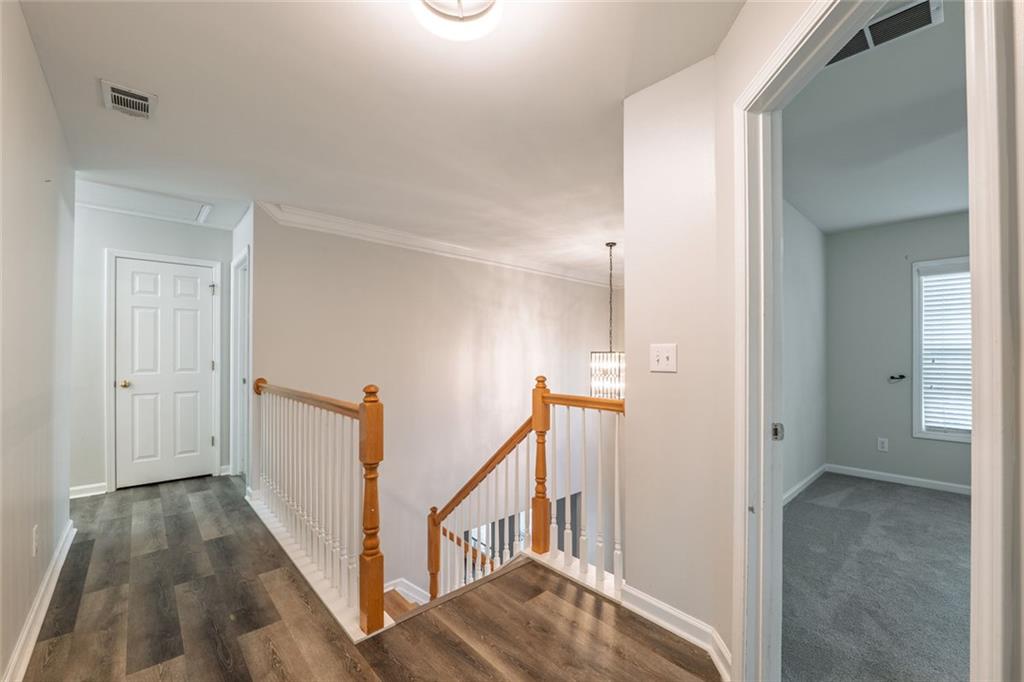 1280 Hidden Creek Point Cumming, GA 30040 - Photo 21 of 62 a view of a hallway with white walls and stairs