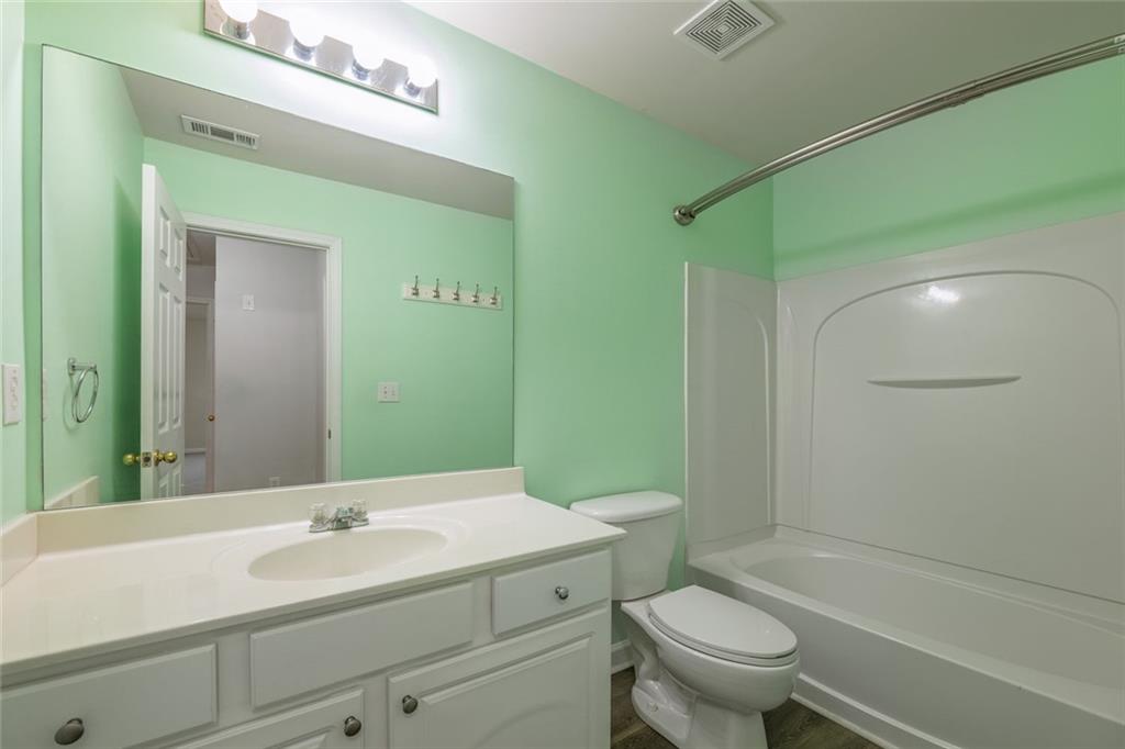 1280 Hidden Creek Point Cumming, GA 30040 - Photo 25 of 62 a bathroom with a sink a toilet and shower