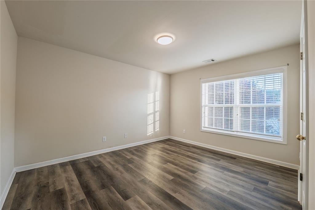 1280 Hidden Creek Point Cumming, GA 30040 - Photo 26 of 62 an empty room with wooden floor and windows