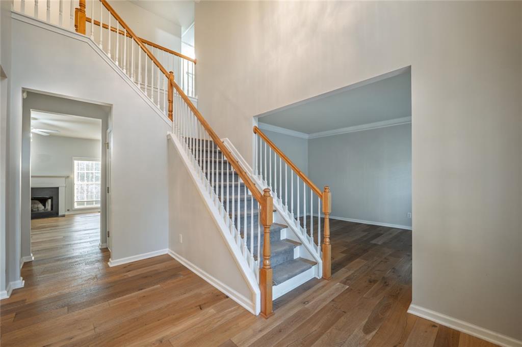 1280 Hidden Creek Point Cumming, GA 30040 - Photo 3 of 62 a view of a hallway with wooden floor and staircase