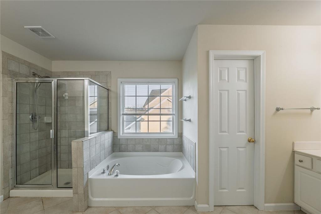 1280 Hidden Creek Point Cumming, GA 30040 - Photo 32 of 62 a bathroom with a bathtub and a shower