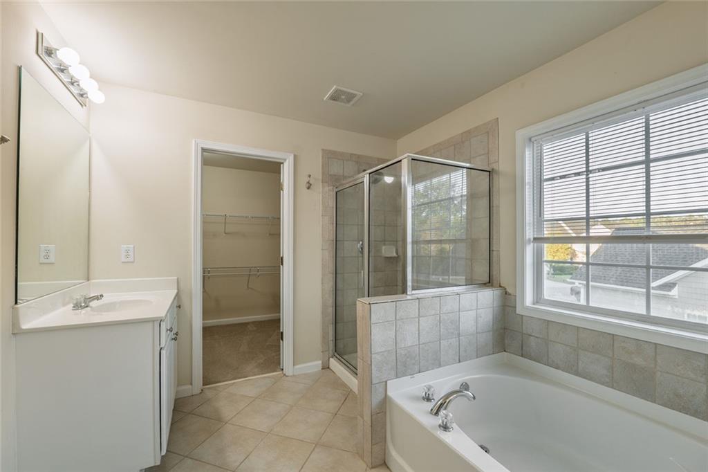 1280 Hidden Creek Point Cumming, GA 30040 - Photo 33 of 62 a bathroom with a tub shower and sink