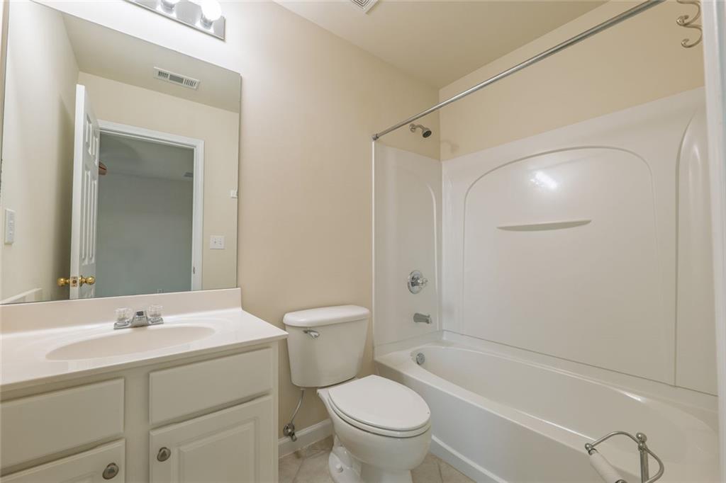 1280 Hidden Creek Point Cumming, GA 30040 - Photo 39 of 62 a bathroom with a toilet a sink and a bathtub