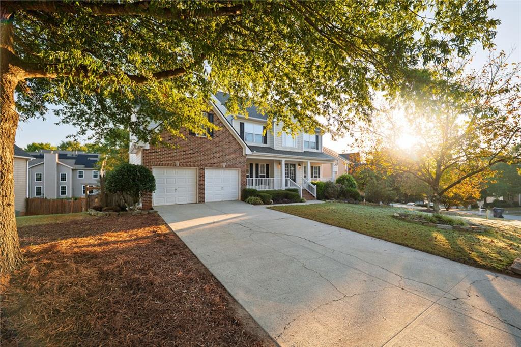 1280 Hidden Creek Point Cumming, GA 30040 - Photo 44 of 62 a front view of a house with a yard and garage