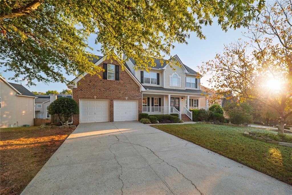 1280 Hidden Creek Point Cumming, GA 30040 - Photo 46 of 62 a front view of a house with a yard and garage