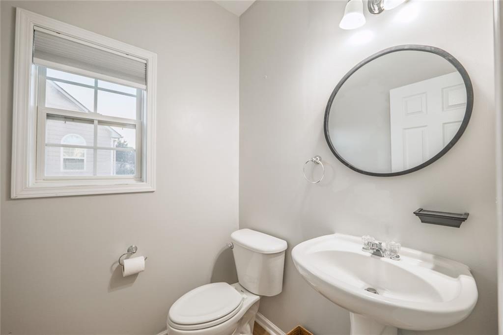 1280 Hidden Creek Point Cumming, GA 30040 - Photo 7 of 62 a bathroom with a sink a mirror and a toilet