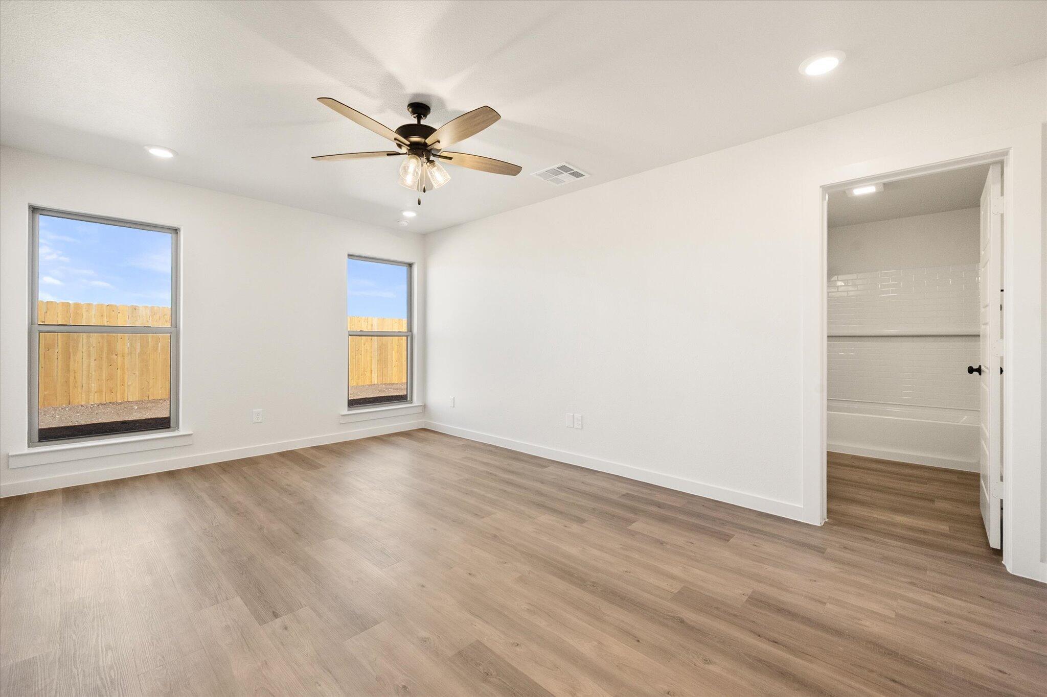 3114 138th Place Lubbock, TX 79423 - Photo 12 of 21 a view of an empty room with wooden floor and a window