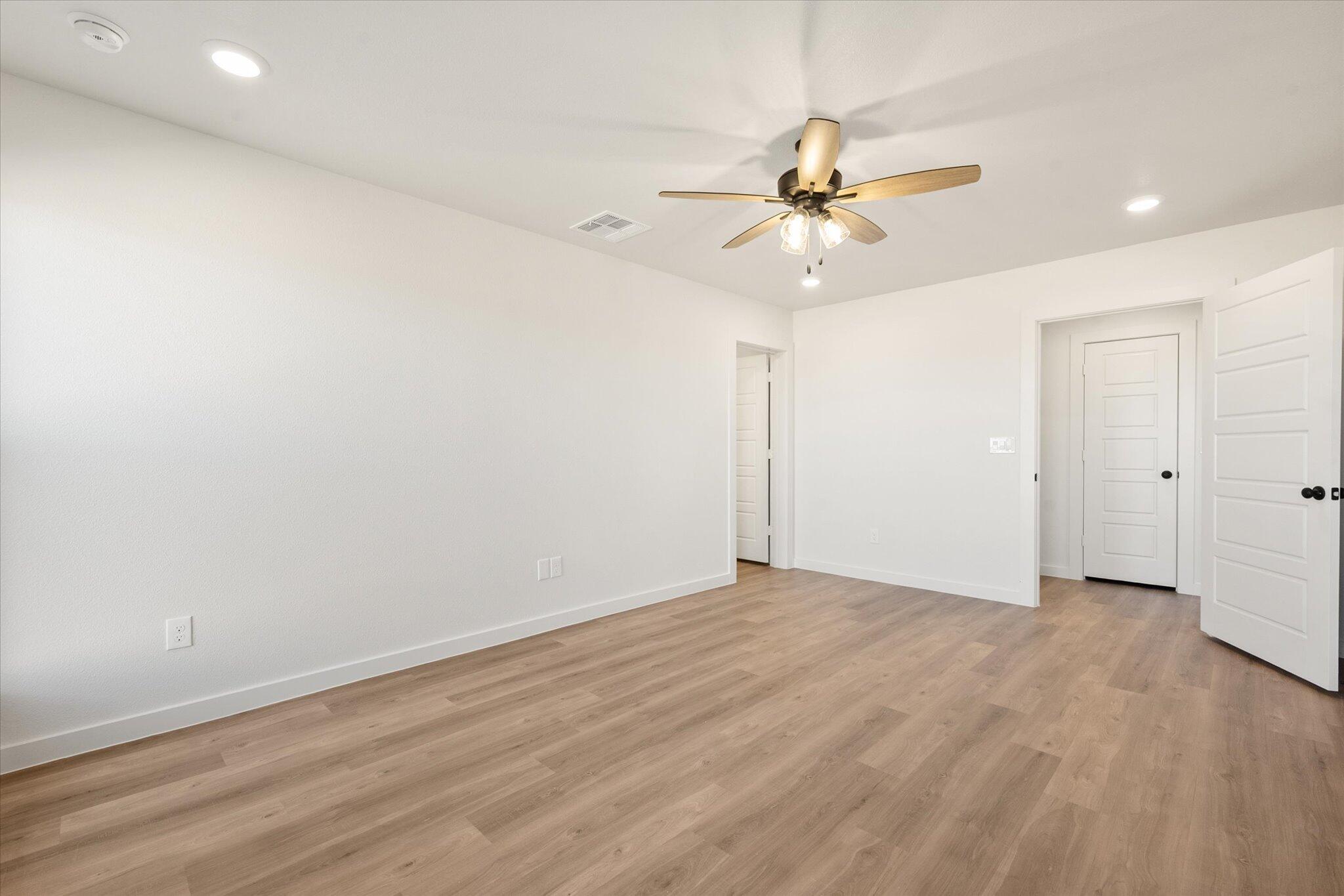 3114 138th Place Lubbock, TX 79423 - Photo 13 of 21 wooden floor in an empty room with a window