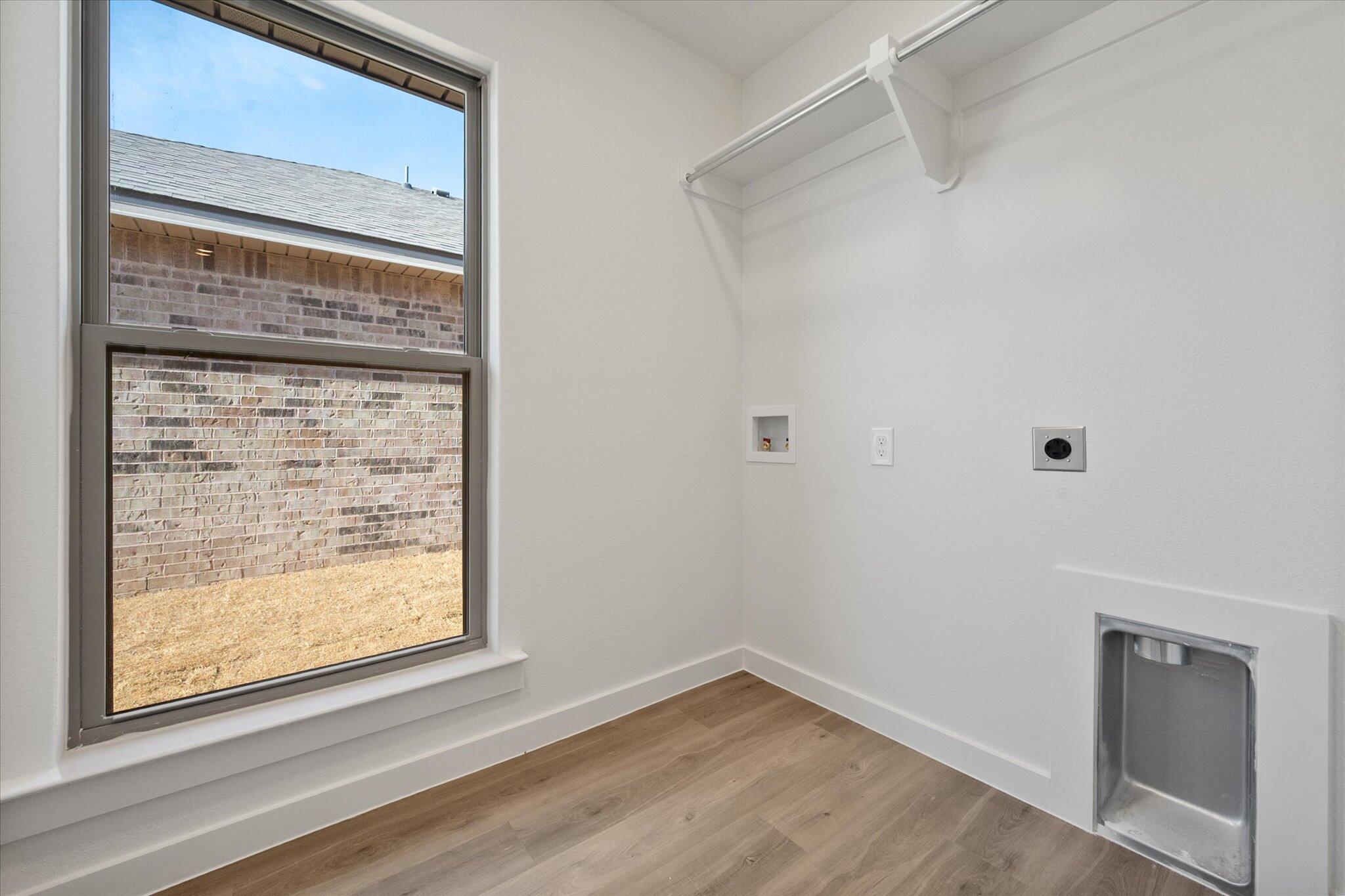 3114 138th Place Lubbock, TX 79423 - Photo 19 of 21 a view of an empty room with wooden floor and a window