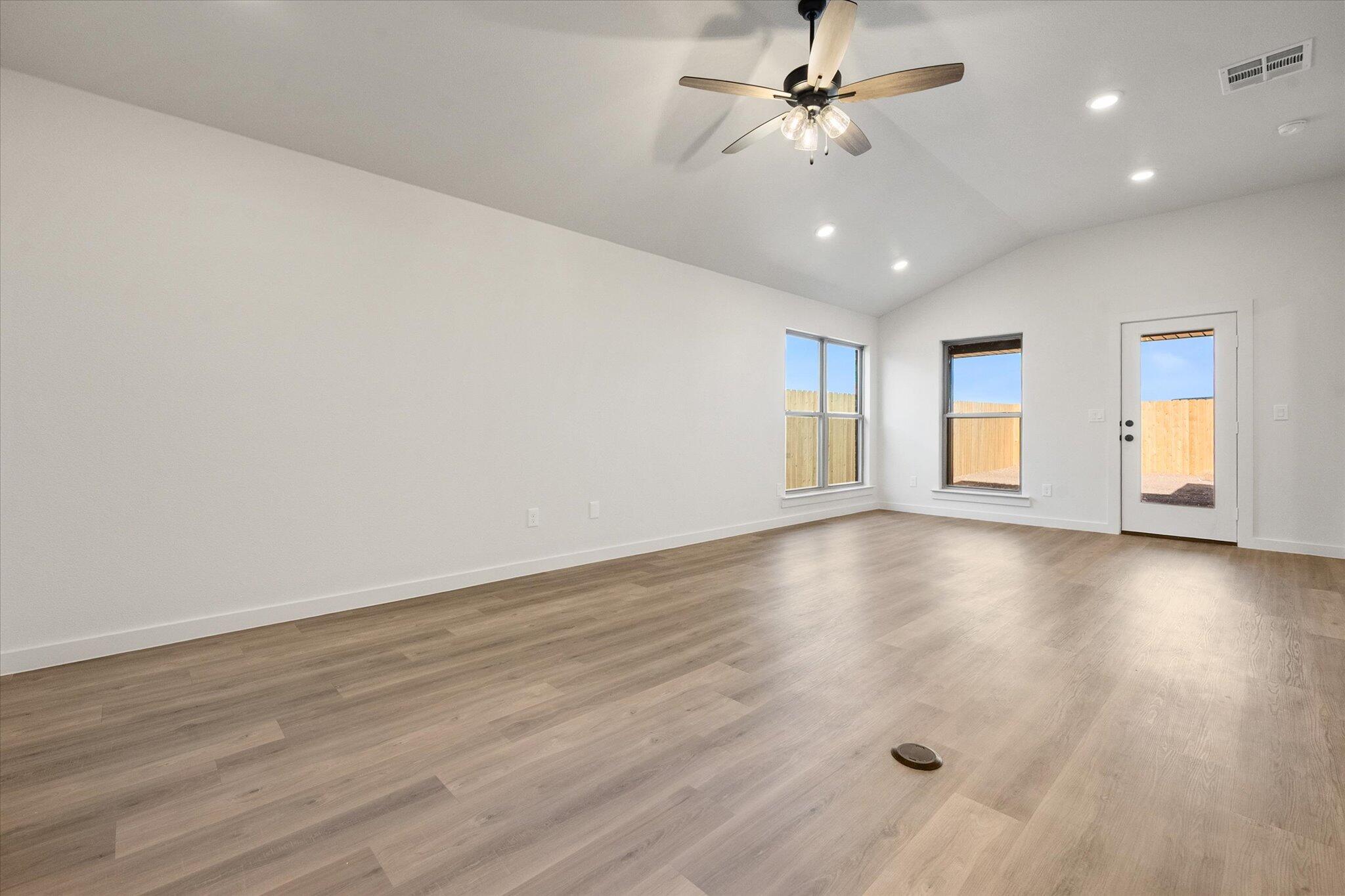 3114 138th Place Lubbock, TX 79423 - Photo 3 of 21 wooden floor in an empty room with a window