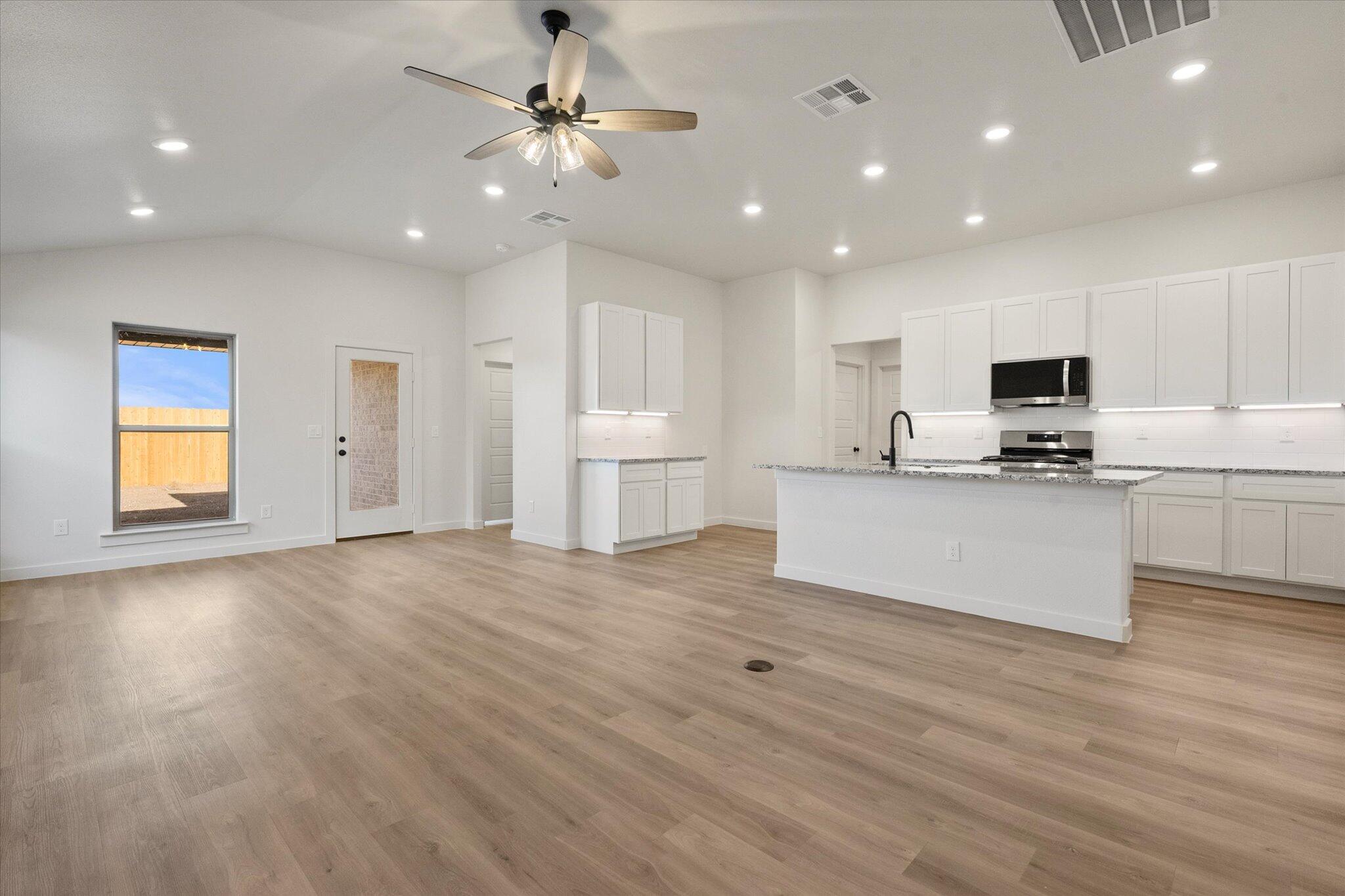 3114 138th Place Lubbock, TX 79423 - Photo 4 of 21 a view of kitchen with cabinets and wooden floor