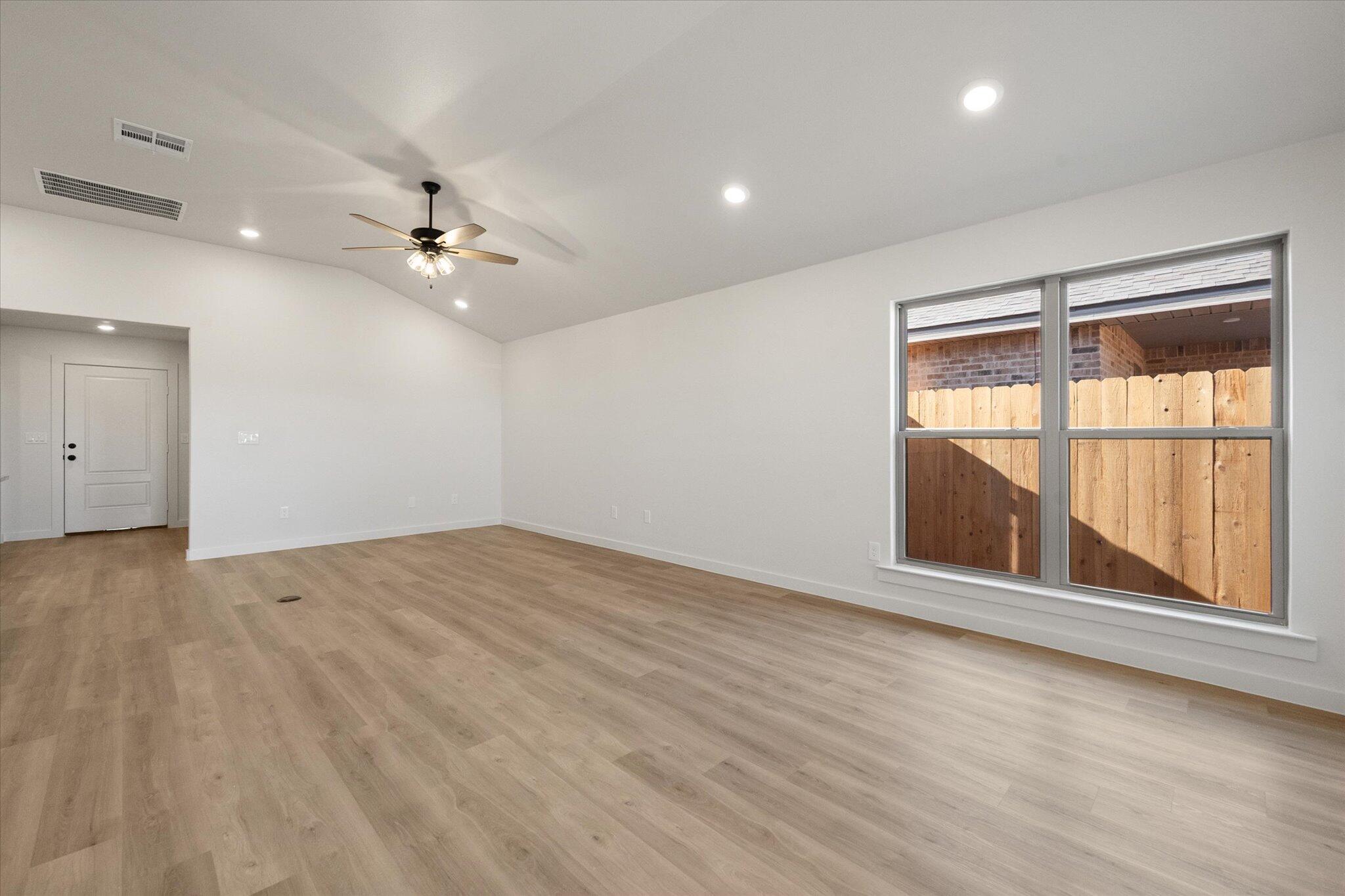 3114 138th Place Lubbock, TX 79423 - Photo 5 of 21 wooden floor in an empty room with a window