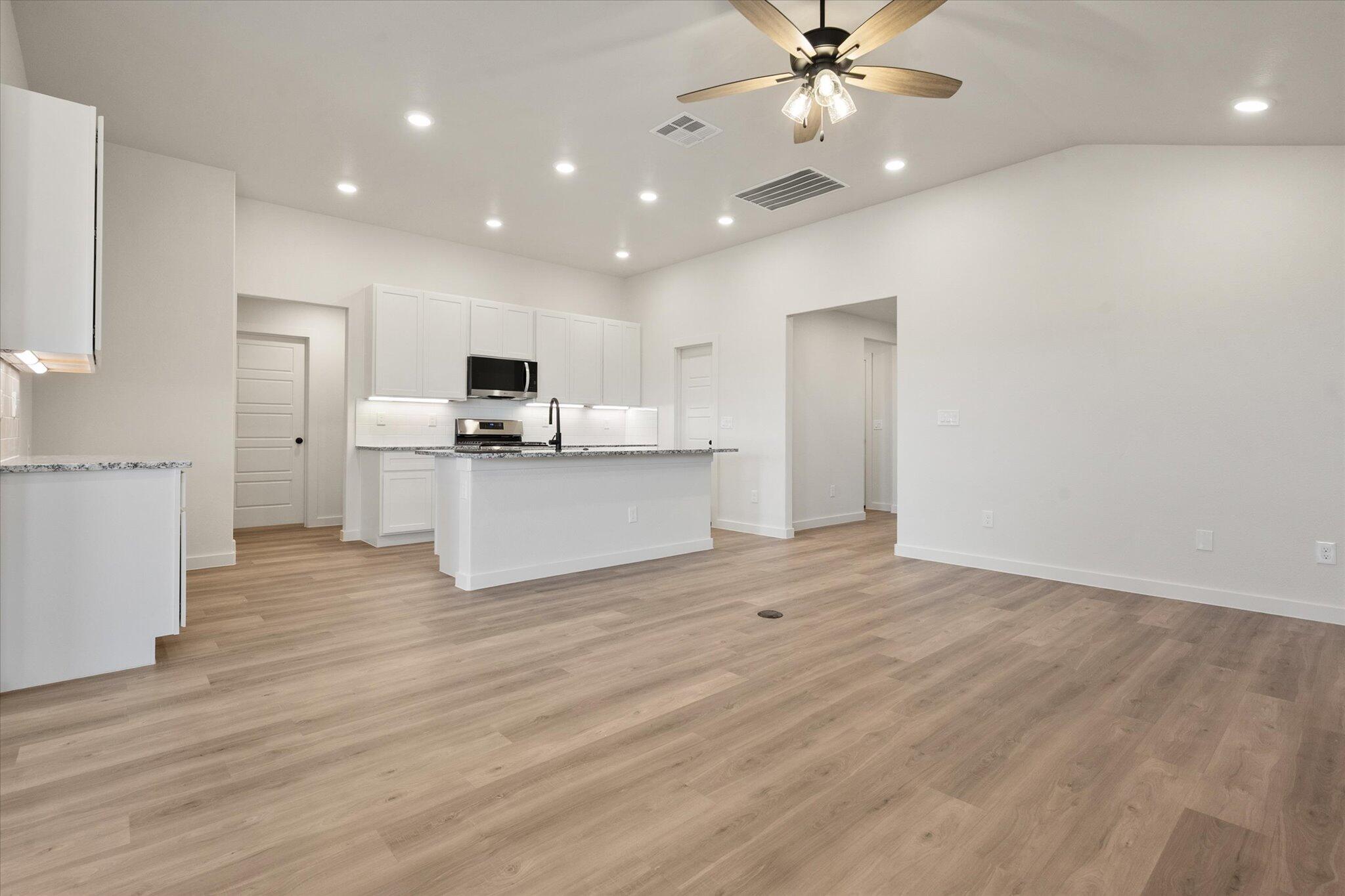 3114 138th Place Lubbock, TX 79423 - Photo 6 of 21 a view of a kitchen with a sink and a refrigerator