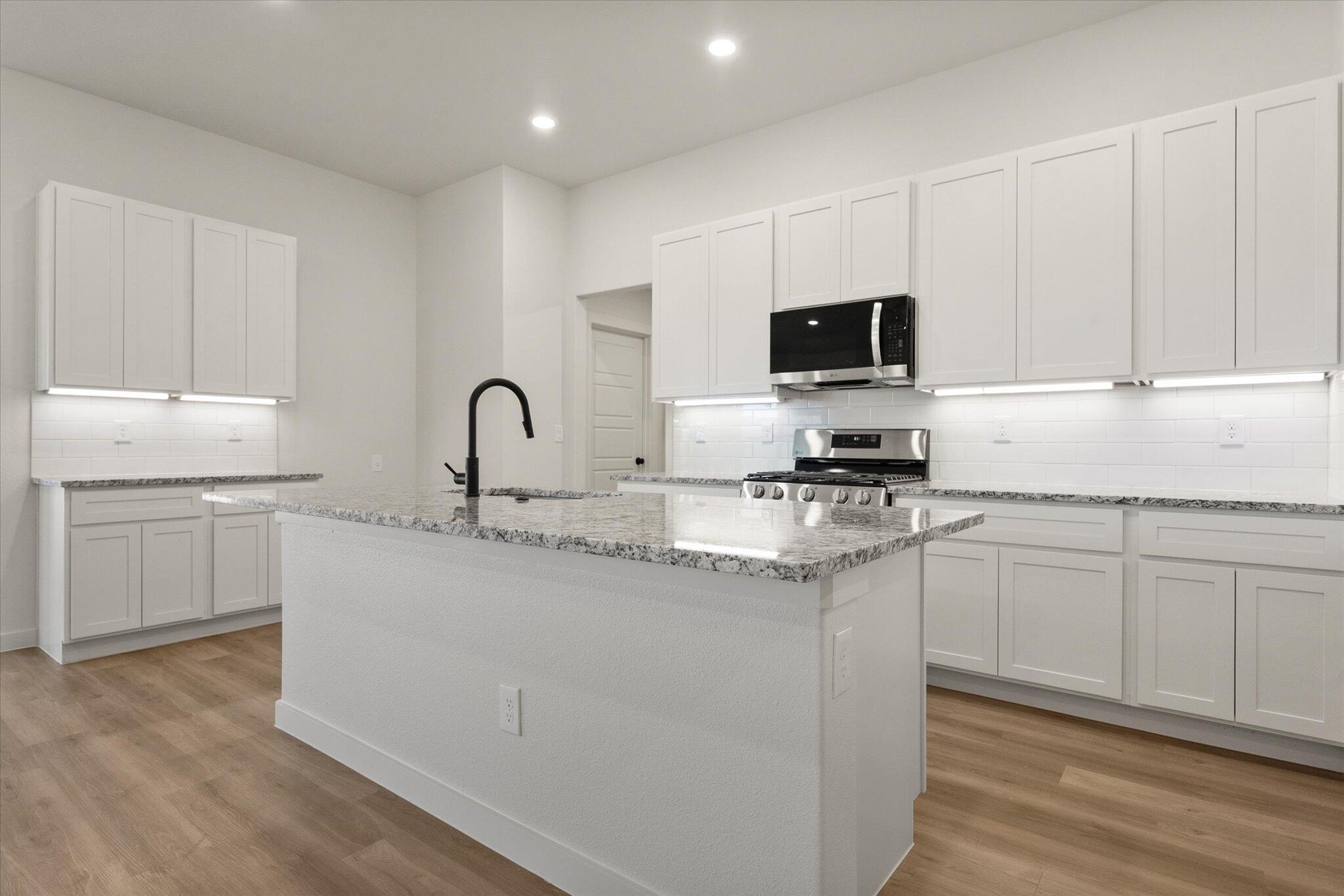 3114 138th Place Lubbock, TX 79423 - Photo 9 of 21 a kitchen with granite countertop white cabinets and white appliances