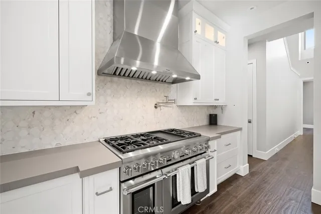 a large white kitchen with a large window