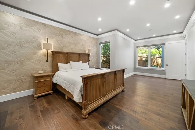 a bedroom with a bed and a large window