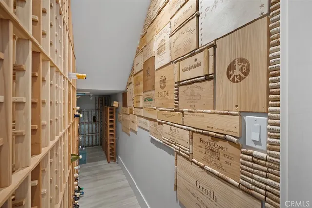 a bedroom with furniture a flat screen tv and a window