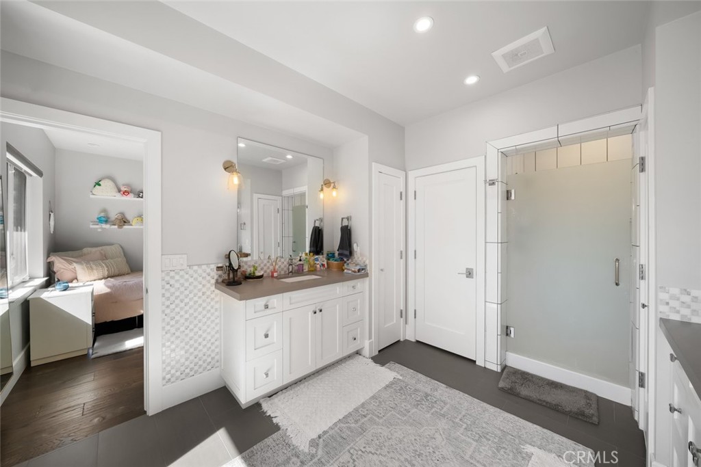 2207 San Luis Drive San Luis Obispo, CA 93401 - Photo 47 of 58 a bathroom with a sink a mirror and a shower
