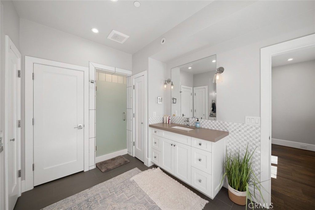 2207 San Luis Drive San Luis Obispo, CA 93401 - Photo 48 of 58 a spacious bathroom with a double vanity sink and a mirror