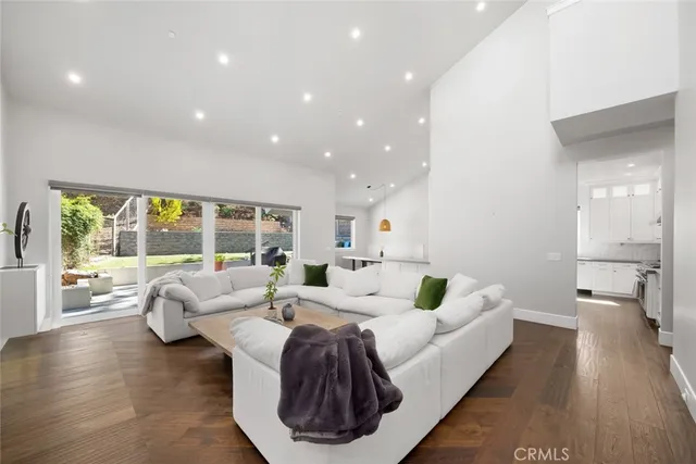 a kitchen with stainless steel appliances granite countertop a sink a stove and a wooden floors