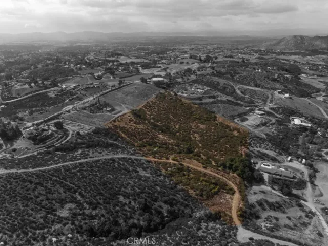 an aerial view of house with yard and mountain view in back