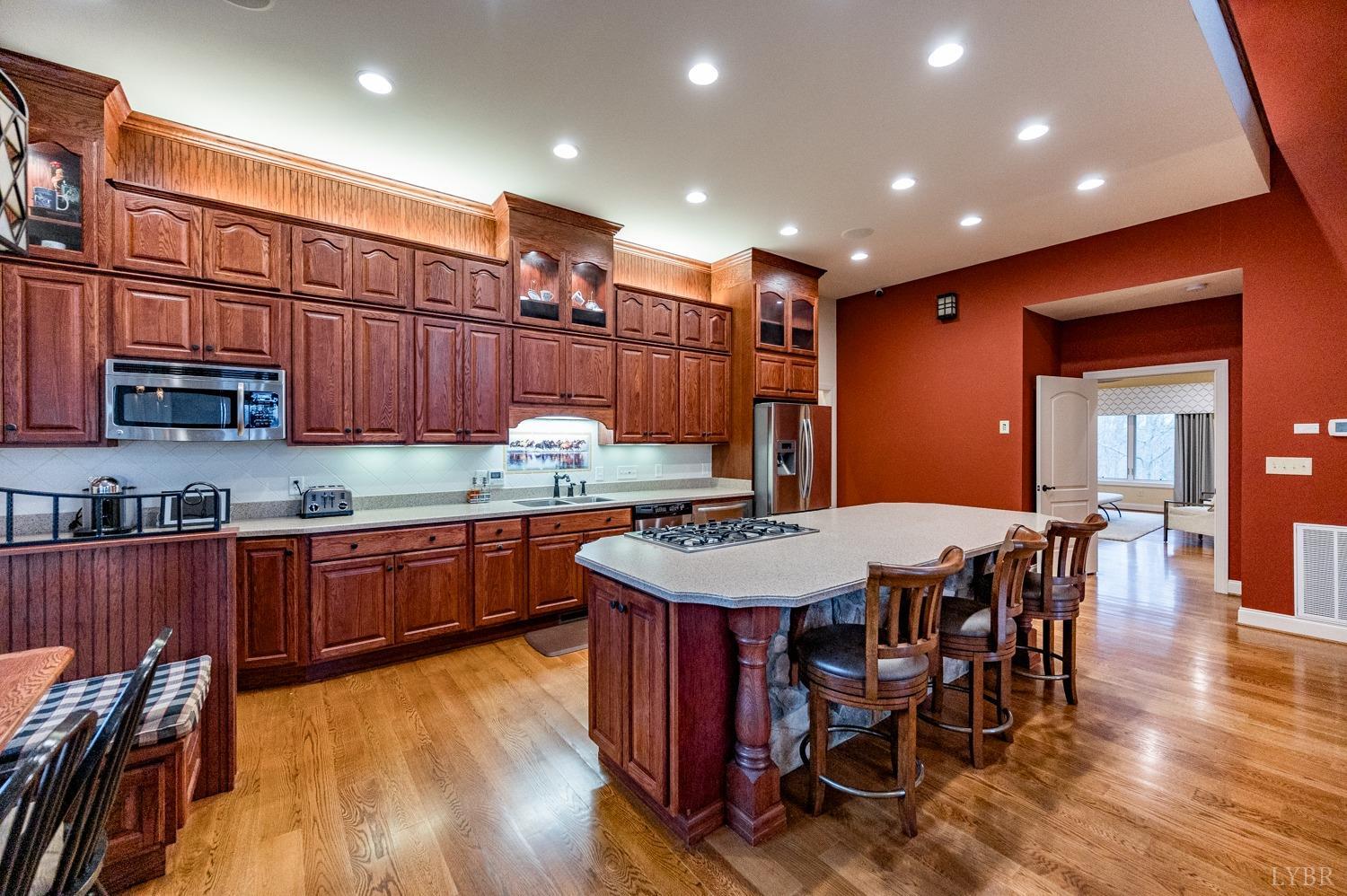 657 Cherry Hill Road Amherst, VA 24521 - Photo 18 of 91 a kitchen with stainless steel appliances granite countertop a kitchen island hardwood floor sink dining table and chairs